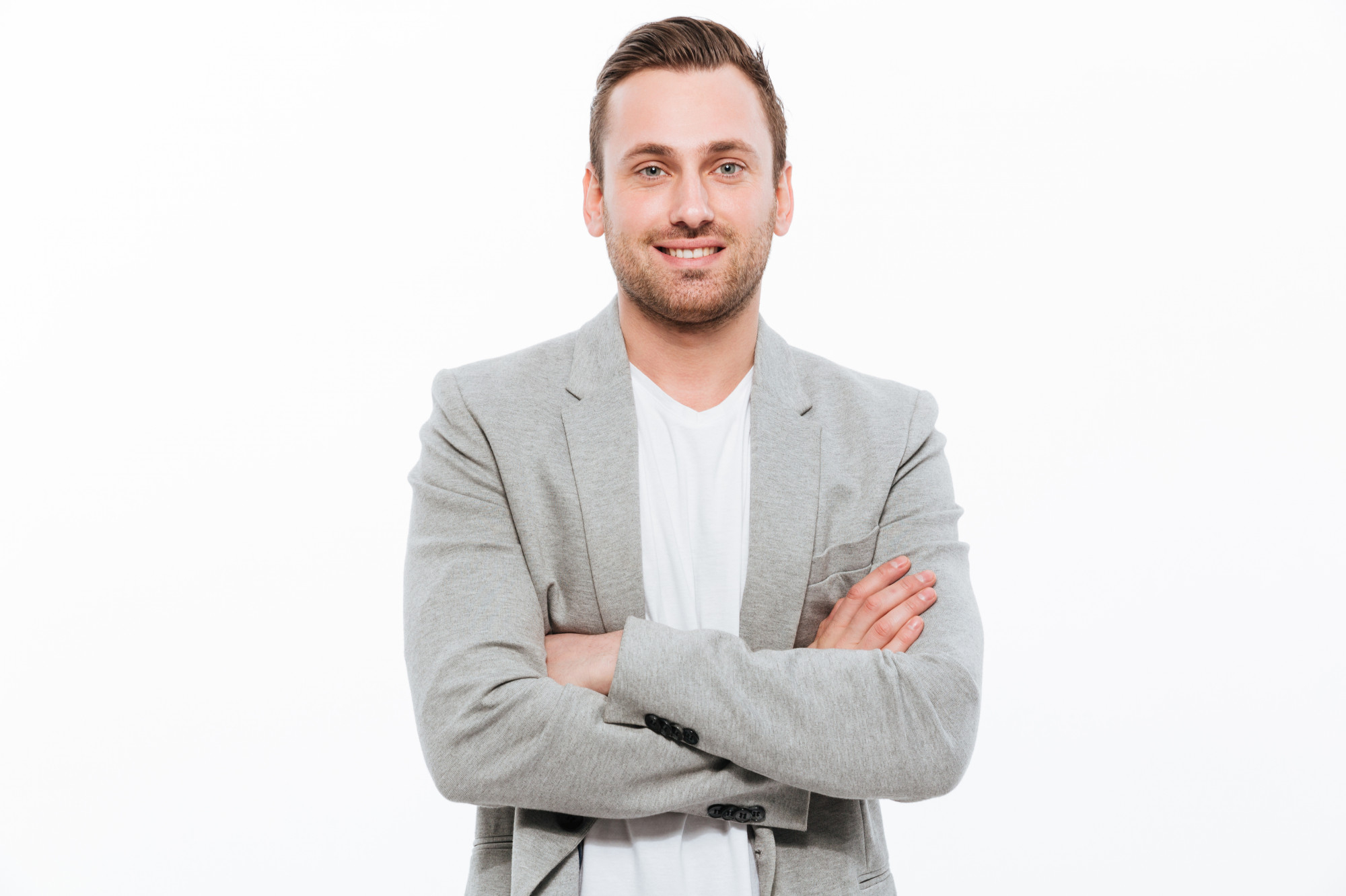 portrait-successful-man-having-stubble-posing-with-broad-smile-keeping-arms-folded