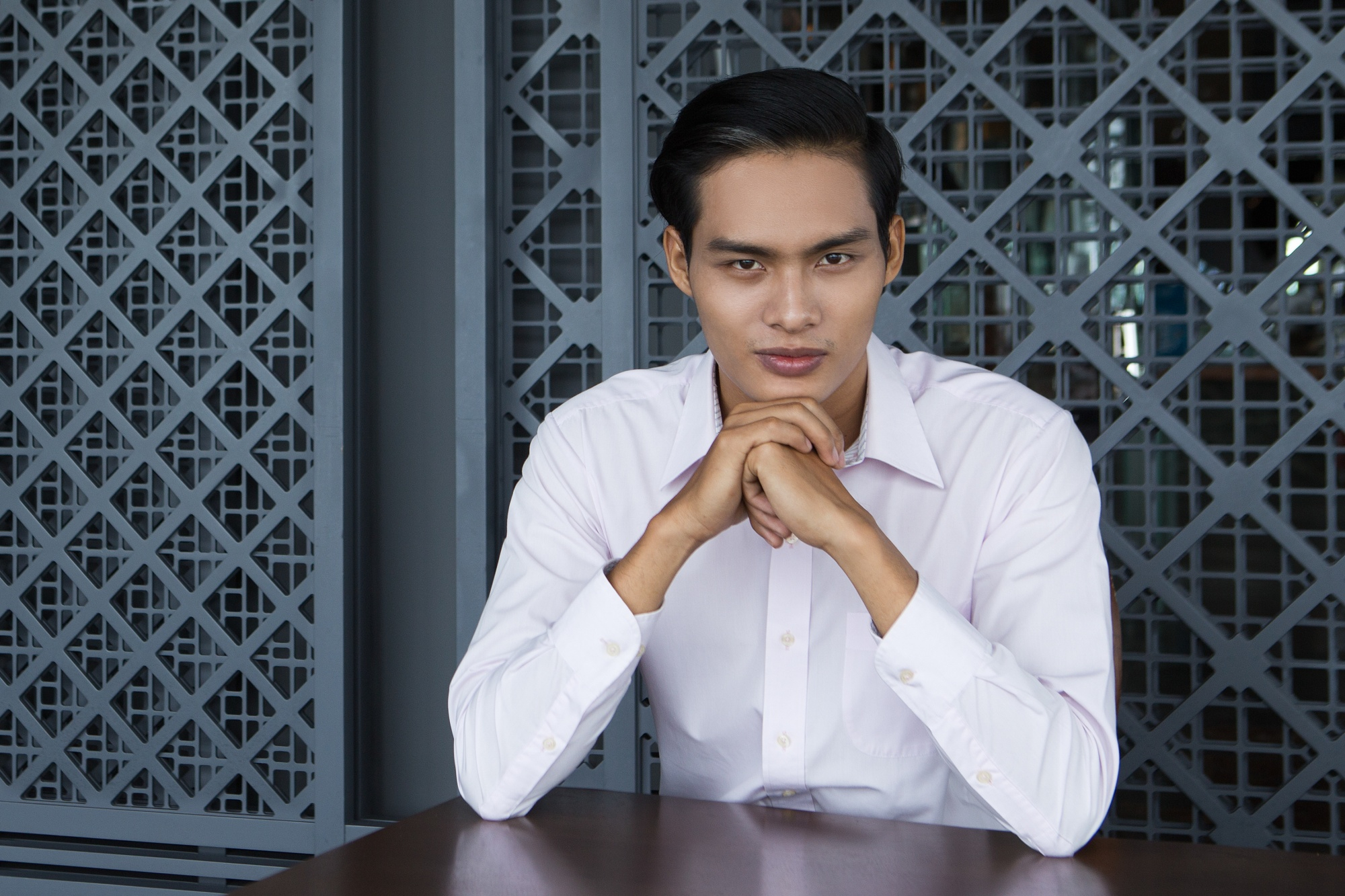young-asian-man-sitting-with-hands-chin